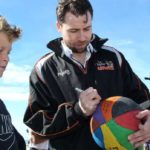 Zico Coronel signs basketball for a young fan